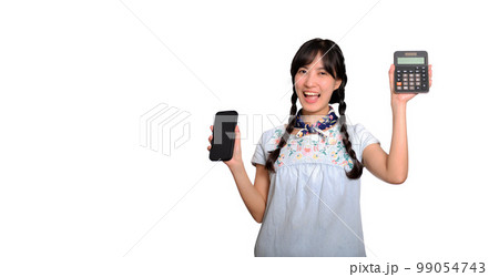 Portrait of beautiful young asian woman in denim dress holding calculator and smartphone on white background. business shopping online concept. Portrait of beautiful young asian woman in denim dress holding calculator and smartphone on white background. business shopping online concept. 99054743