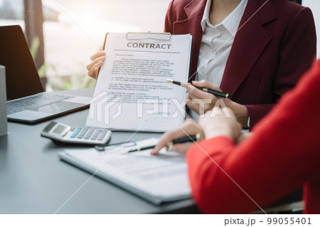 Real estate broker agent presenting and consult to customer to decision making sign insurance form agreement, home model, concerning mortgage loan offer. Real estate broker agent presenting and consult to customer to decision making sign insurance form agreement, home model, concerning mortgage loan offer. 99055401