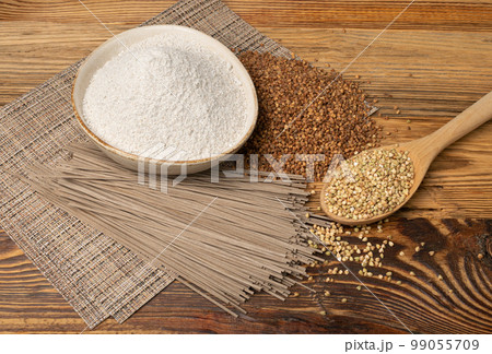 Buckwheat Flour Pile in Wood Bowl, Dry Buck Wheat Powder, Buckwheat Flour on Wooden Rustic Background 99055709