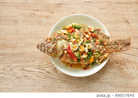 fried mango fish dressing spicy sauce herb sauce on plate 99057645