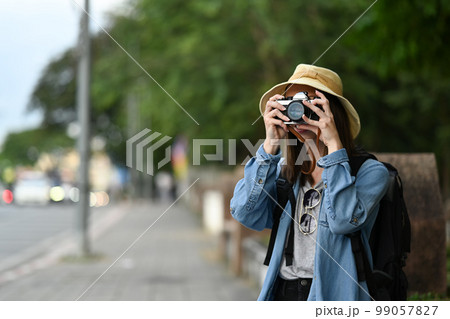 Young female photographer tourist taking photo at major tourist attraction in Chiang Mai Northern Thailand 99057827