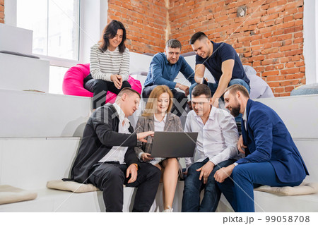 a group of men and women in coworking. the concept of teamwork. a group of men and women in coworking. the concept of teamwork. 99058708