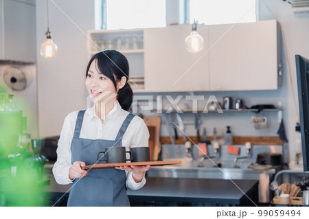 カフェのホールスタッフとして働く女性 カフェのホールスタッフとして働く女性 99059494