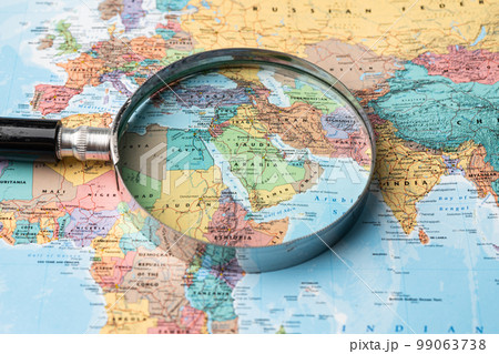 Bangkok, Thailand - January 20, 2022 Asia, Magnifying glass close up with colorful world map, travel, geography, tourism and exploration concept. Bangkok, Thailand - January 20, 2022 Asia, Magnifying glass close up with colorful world map, travel, geography, tourism and exploration concept. 99063738