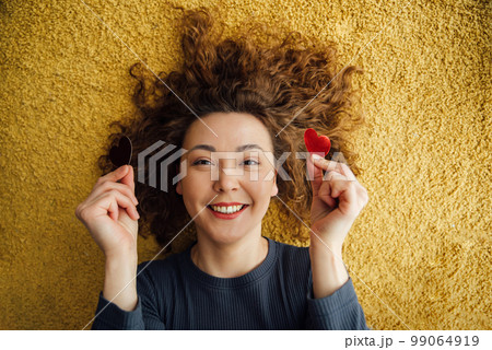 Smiling happy woman with hearts in her hands. 99064919