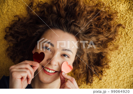 Close-up portrait of a woman in love with hearts on her face Close-up portrait of a woman in love with hearts on her face 99064920