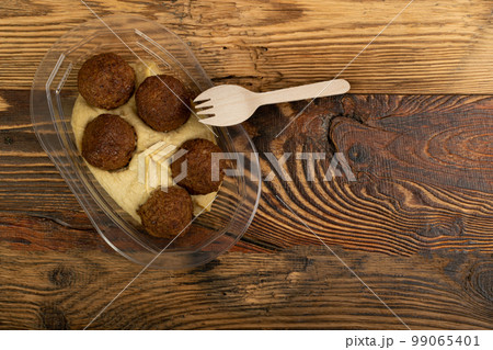 Falafel Balls in a Plastic Container, Fried Chickpea Balls, Traditional Arabic Street Food, Falafel on White Background 99065401