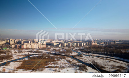City park in winter. Snow lies on the ground. A meandering river flows. Aerial photography. City park in winter. Snow lies on the ground. A meandering river flows. Aerial photography. 99066347