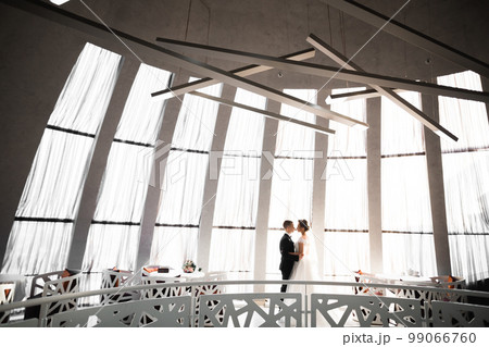 Romantic wedding moment, couple of newlyweds smiling portrait, bride and groom hugging Romantic wedding moment, couple of newlyweds smiling portrait, bride and groom hugging 99066760