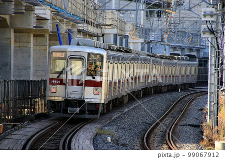 踏切の在る風景もあと僅か…　タワーの麓の下町を快走する通勤型ステンレス車 99067912
