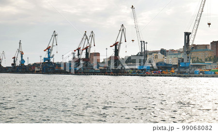 The seaport of Vladivostok with cranes. View from the ferry. The seaport of Vladivostok with cranes. View from the ferry. 99068082
