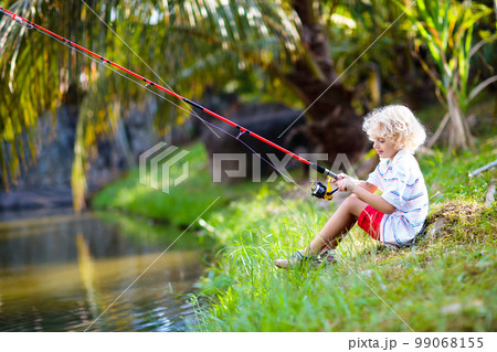 Boy fishing. Child with rod catching fish in river Boy fishing. Child with rod catching fish in river 99068155