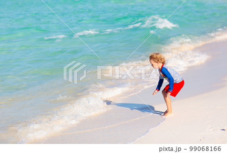 Kids playing on beach. Children play at sea. 99068166