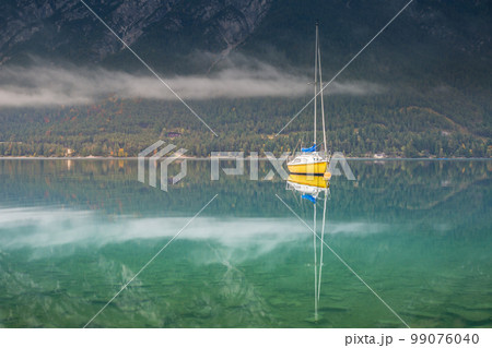 Sailboats on Achensee lake near Innsbruck at peaceful dawn, Tyrol alps, Austria 99076040