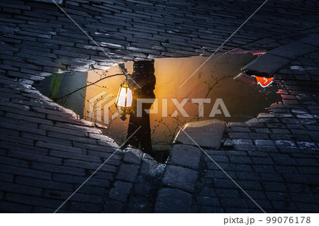 Vilnius old town, puddle reflection illuminated at night, Lithuania, Baltics Vilnius old town, puddle reflection illuminated at night, Lithuania, Baltics 99076178