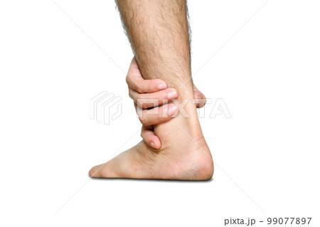 Ankle Pain man sitting on wooden background holding her feet. Health concept. 99077897
