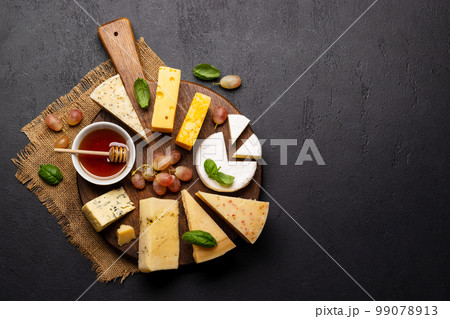 Various cheese on board 99078913