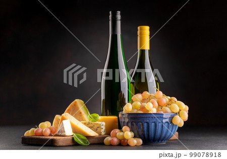 Various cheese on board and white wine Various cheese on board and white wine 99078918