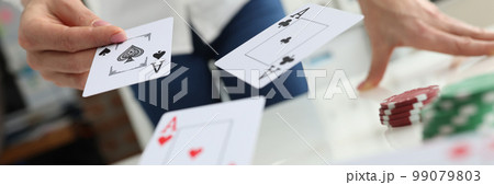 Person throws playing cards on table closeup Person throws playing cards on table closeup 99079803