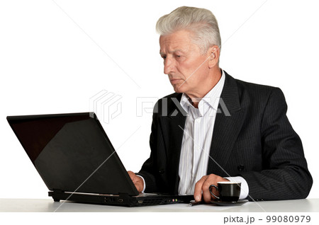 Old businessman with laptop isolated on white background 99080979