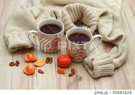 Winter concept with tea for two, sweater and tangerines 99081828