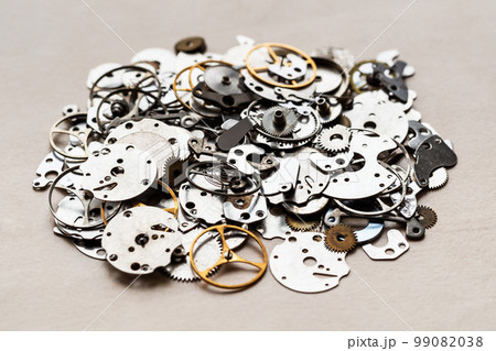 pile of spare-parts for mechanical clocks closeup 99082038