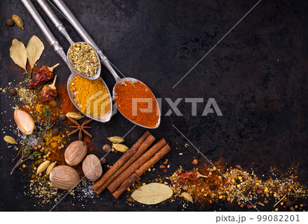 Different spices and herbs on a black background 99082201