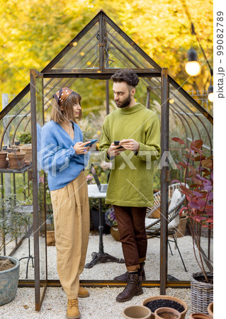 Stylish couple hang out in garden Stylish couple hang out in garden 99082789