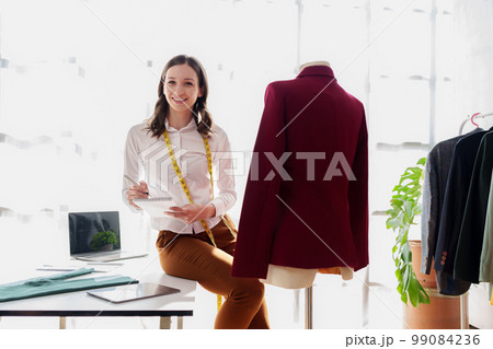 Beautiful young professional stylist working at design studio interior. fashion designer concept 99084236