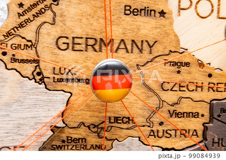 Germany flag pins and red thread for traveling and planning trips. Planning of logistics routes or spheres of influence in geopolitics Germany flag pins and red thread for traveling and planning trips. Planning of logistics routes or spheres of influence in geopolitics 99084939