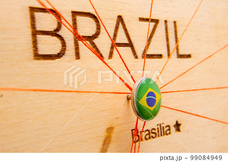Brazil flag pins and red thread for traveling and planning trips. Planning of logistics routes or spheres of influence in geopolitics Brazil flag pins and red thread for traveling and planning trips. Planning of logistics routes or spheres of influence in geopolitics 99084949