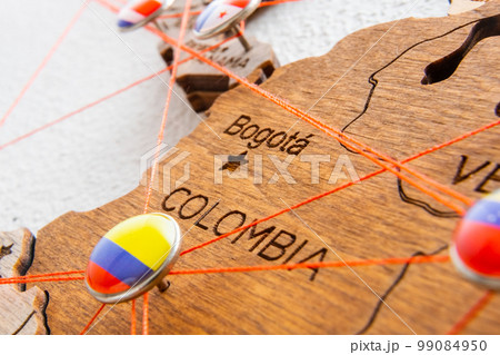 Colombia flag pins and red thread for traveling and planning trips. Planning of logistics routes or spheres of influence in geopolitics Colombia flag pins and red thread for traveling and planning trips. Planning of logistics routes or spheres of influence in geopolitics 99084950