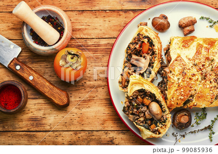Homemade savoury mushroom pie with and persimmon Homemade savoury mushroom pie with and persimmon 99085936