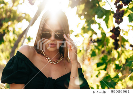 Portrait of a young beautiful smiling woman in a vineyard 99086961