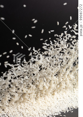 Japanese Rice flying explosion, white grain rices explode abstract cloud fly. Beautiful complete seed rice splash in air, food object design. Black background high speed shutter freeze stop motion Japanese Rice flying explosion, white grain rices explode abstract cloud fly. Beautiful complete seed rice splash in air, food object design. Black background high speed shutter freeze stop motion 99087272