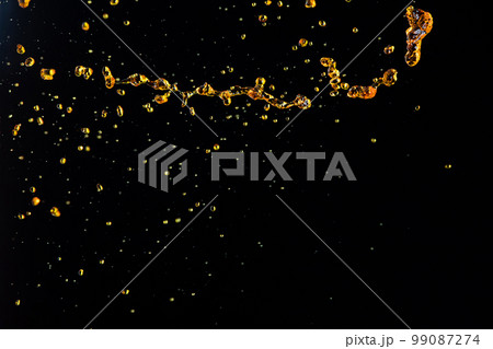 Orange, lemon juice or oil lubricant splash, liquid gold yellow drink drops. Fruit beverage water elements in line form . Fresh splashing and flowing jets, black background isolated freeze motion 99087274