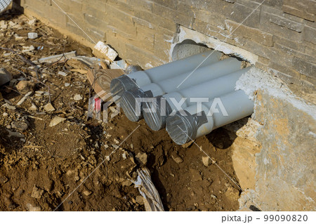 Installation new plastic sewer pipes on ground at trench during assembly Installation new plastic sewer pipes on ground at trench during assembly 99090820