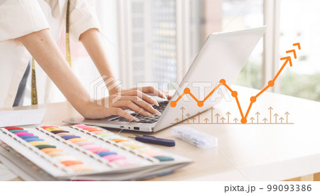 Closeup hand of working designer tailor woman typing laptop computer for digital marketing 99093386
