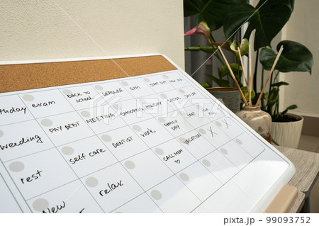 Monthly PLANNER filled with appointments and plans for next month. Busy month schedule Magnetic board with the days of the month. Place to enter important matters schedule. Concept for business 99093752