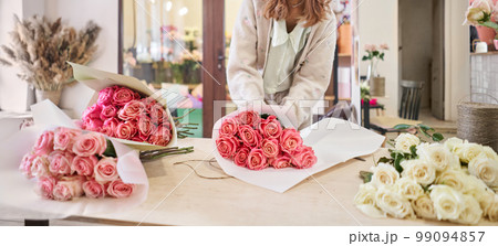 Florist at work. Summer bouquet of roses. Learning flower arranging, making beautiful bouquets with your own hands. Flowers delivery 99094857