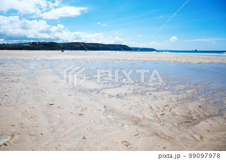 Beautiful Newquay beach with blue sea, stone cliffs and white sand in Cornwall, south west England, selective focus 99097978