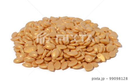 Granules of polymer wax for depilation on a white isolated background Granules of polymer wax for depilation on a white isolated background 99098128