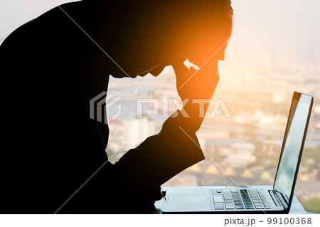 man sitting down, his face unsettled. At the computer desk she has headaches and stress. Cause of hard work and insufficient rest. man sitting down, his face unsettled. At the computer desk she has headaches and stress. Cause of hard work and insufficient rest. 99100368
