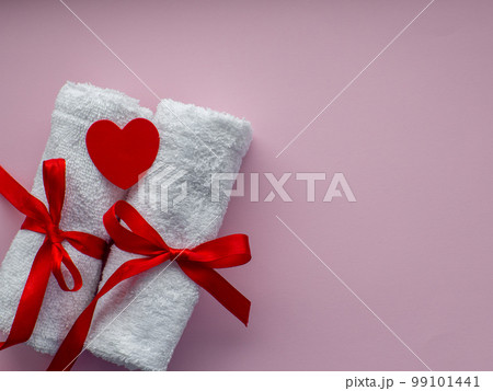 Flat lay with tiny heart-shaped paper, two white towels and space for text Flat lay with tiny heart-shaped paper, two white towels and space for text 99101441