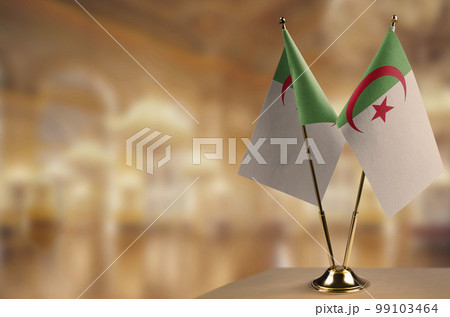 Small flags of the Algeria on an abstract blurry background 99103464