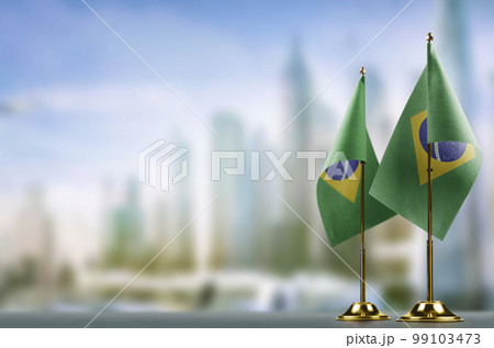 Small flags of the Brazil on an abstract blurry background Small flags of the Brazil on an abstract blurry background 99103473