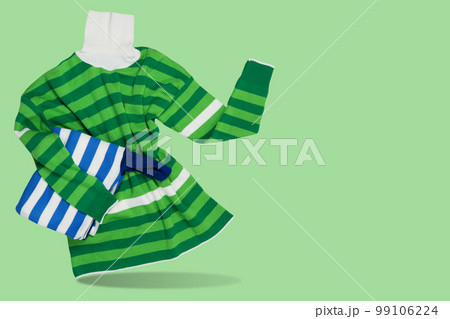 Women's sweater, with green stripes, as if holding a folded sweater, the other hand points to the side, concept 99106224