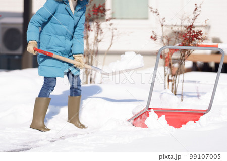 雪掻きする中年女性 99107005