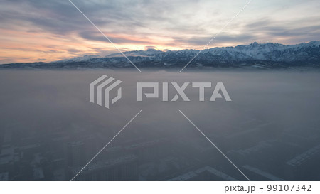 Dawn over the city in fog and smog. Mountain view Dawn over the city in fog and smog. Mountain view 99107342