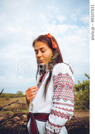Photo of a smiling young woman in ethnic ukrainian shirt Photo of a smiling young woman in ethnic ukrainian shirt 99107831